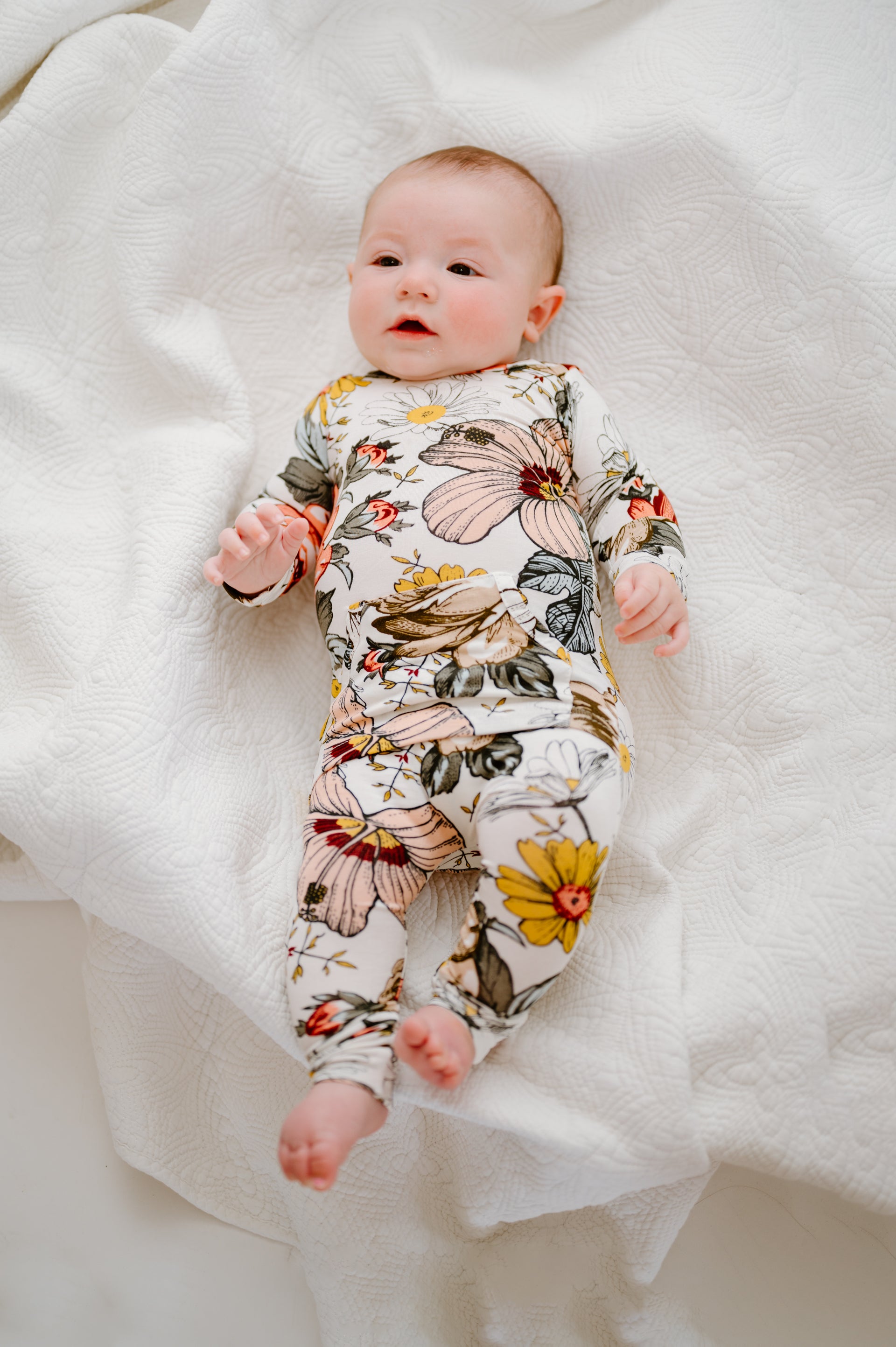 Baby wearing Finley Romper in vintage floral